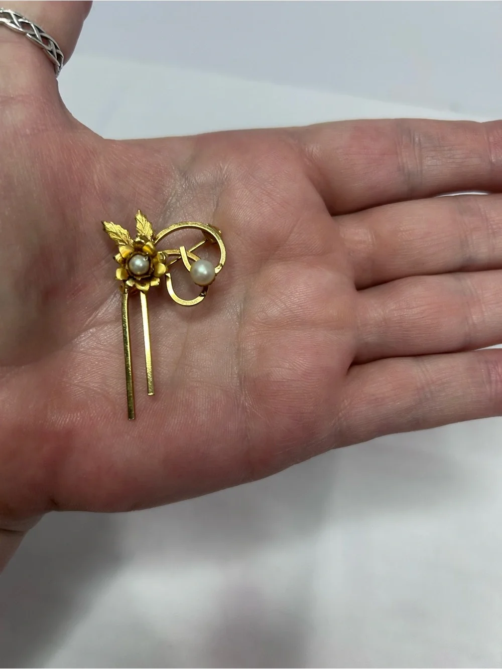 Delicate gold tone flower pin